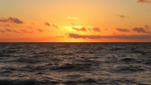 sunset body of water sea