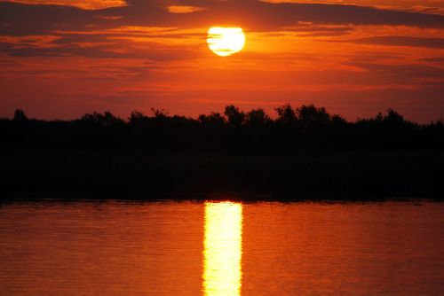 sunset body of water dawn