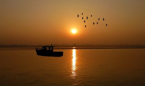 sunset  fishing vessel  sea