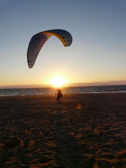 sunset paraglider beach