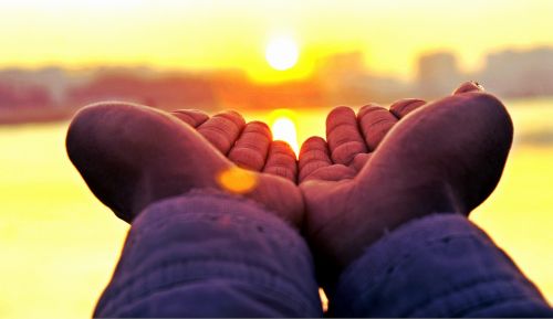 sunset hands holding sun