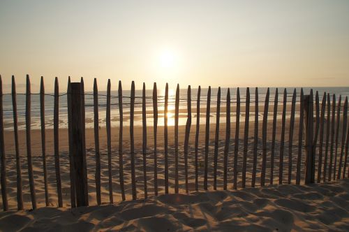 sunset fence ocean