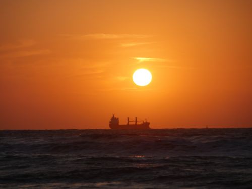 sunset boot ocean