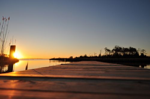 sunset boardwalk water