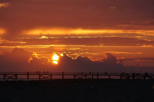 sunset pier clouds