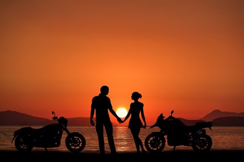 sunset bikes  couple  oceans