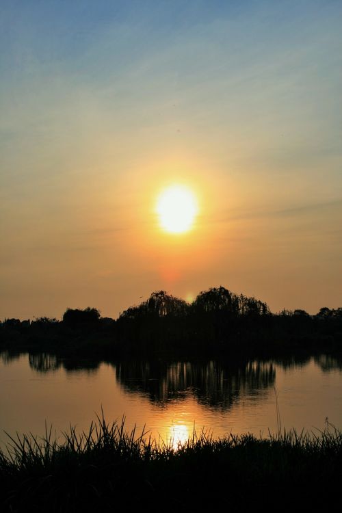 sunset over pond pond water