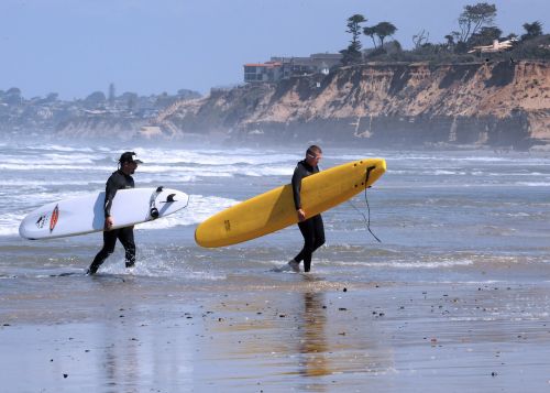 surfers surf surfboard