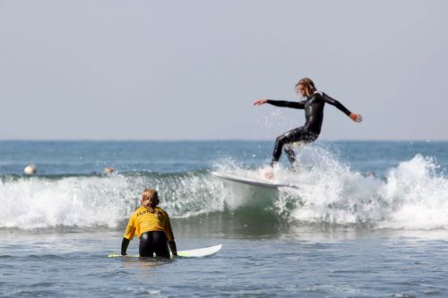 surfers surf surfboard