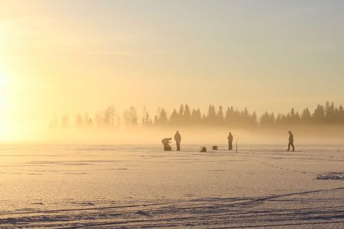 the fisherman on the ice on a winter day