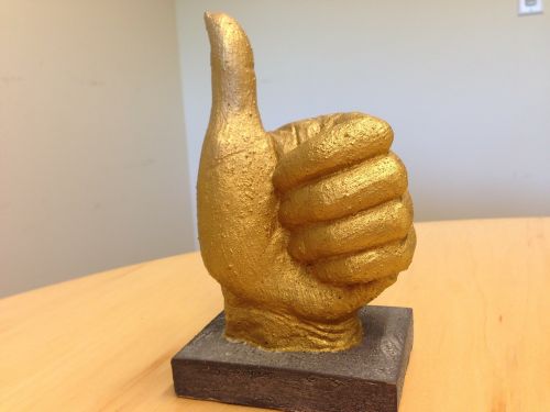 thumbs up statue gold