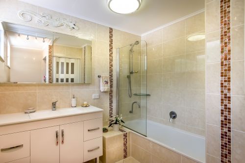 tiled bathroom wall tiles to the ceiling beige tiles