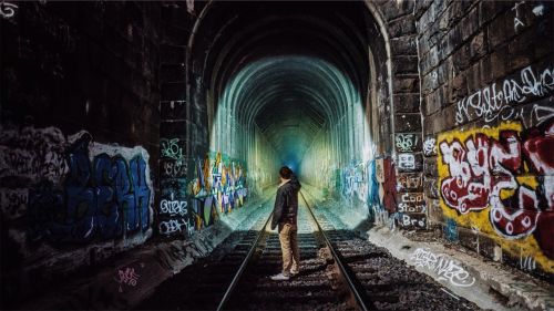 train tracks tunnel graffiti