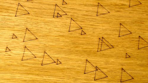 Triangles On Wooden Background