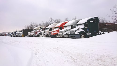 trucks in snow  snow truck  truck yard