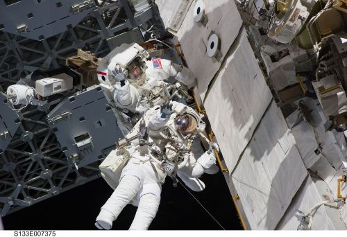 two astronauts spacewalk space shuttle