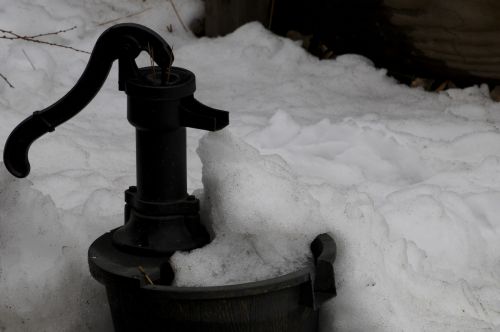 Vintage Water Pump In The Snow