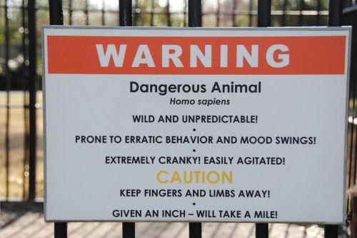warning homo sapiens cage