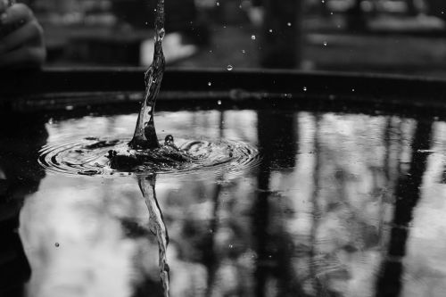 a drop of water water black and white