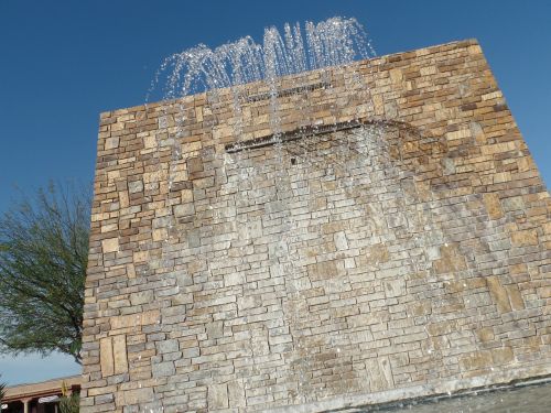 waterfall brick wall blue sky