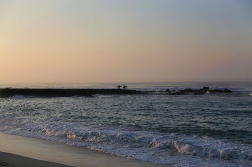 wave-breaker surfers carrying