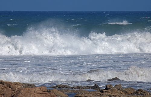 Wave Breaking Behind Rock