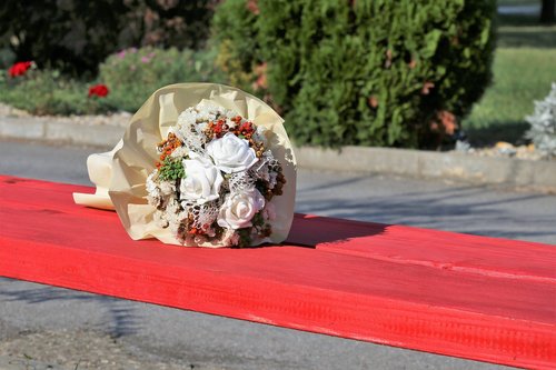 white flower bridal bouquet  colorful  red bench