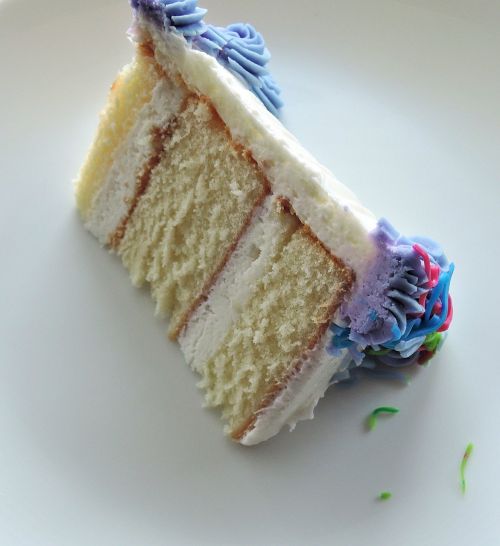 white layer cake sliced sweet frosting