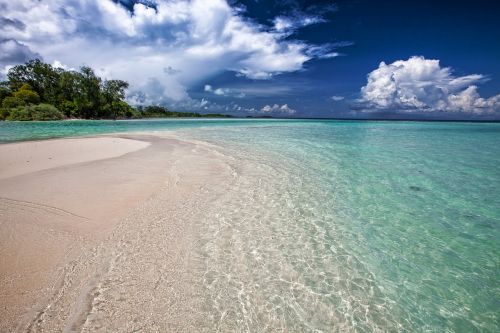 white sand beach ripples the shallow sea