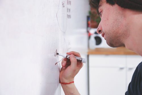 whiteboard writing man