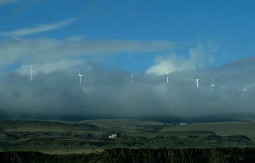 windmills low clouds sky