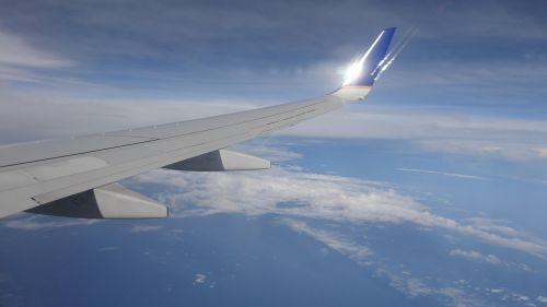 wings aircraft clouds