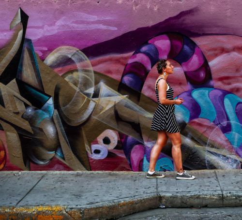 woman walking grafitti