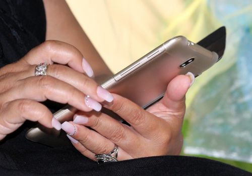 woman mobile phone manicure