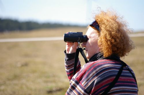 woman redhead binoculars