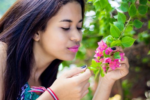 woman girl smelling flower