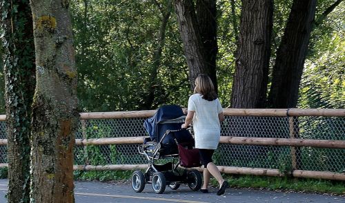 woman baby carriage pedestrian way