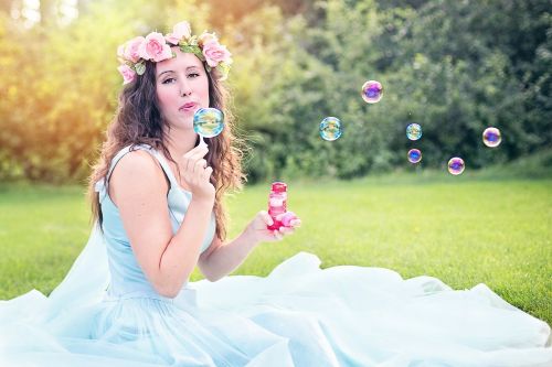 woman blowing bubbles young