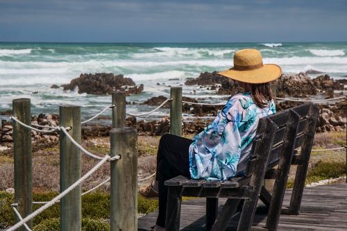 woman sitting seaside rocks