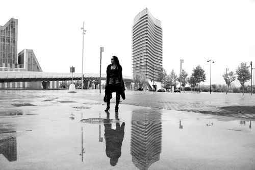 women reflection puddle