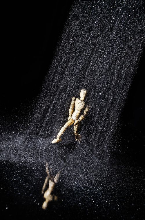 wooden man sand reflection